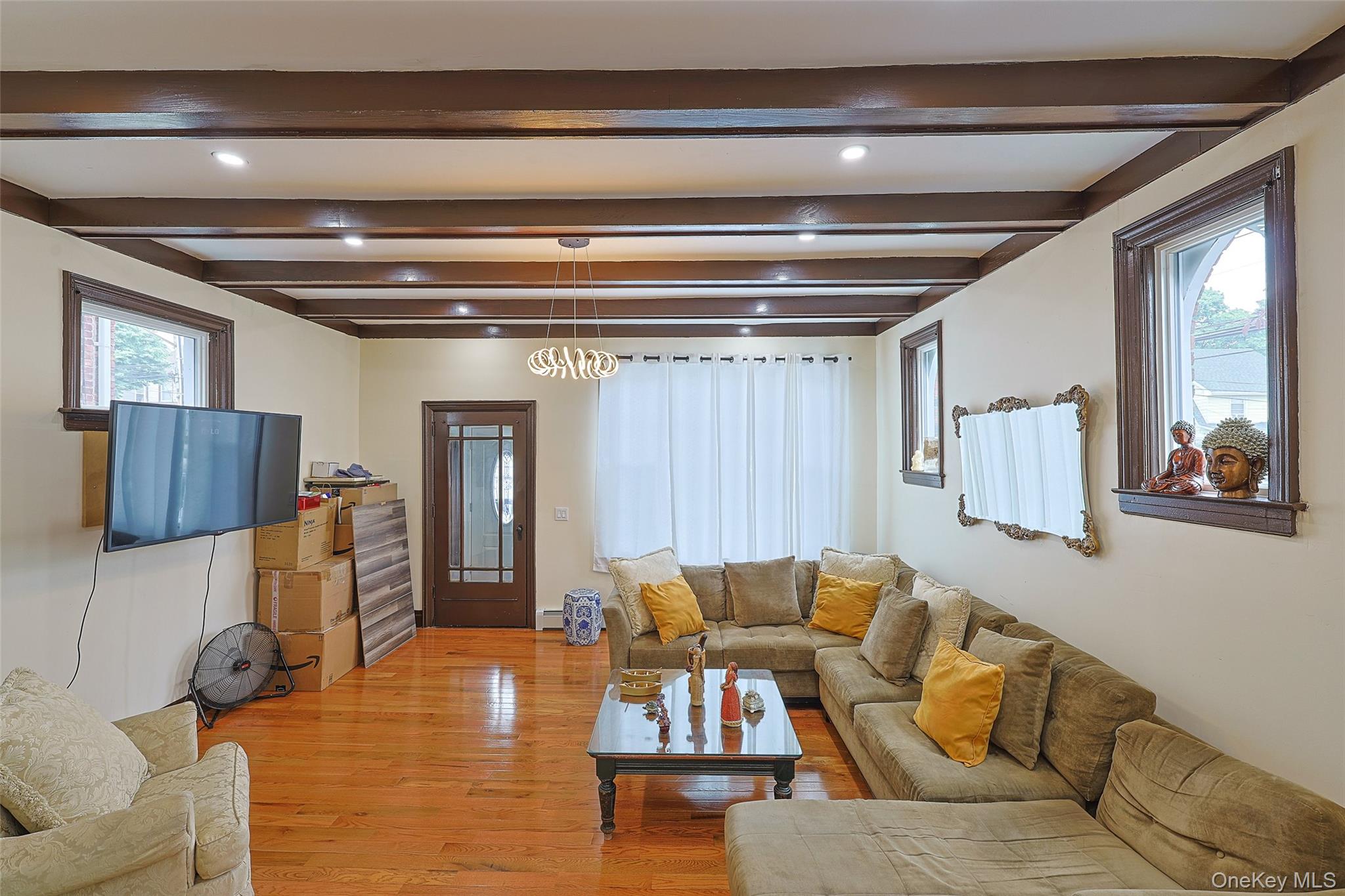 191-68 115th Road Queens, NY 11412 - Photo 3 of 20 a living room with furniture and a window