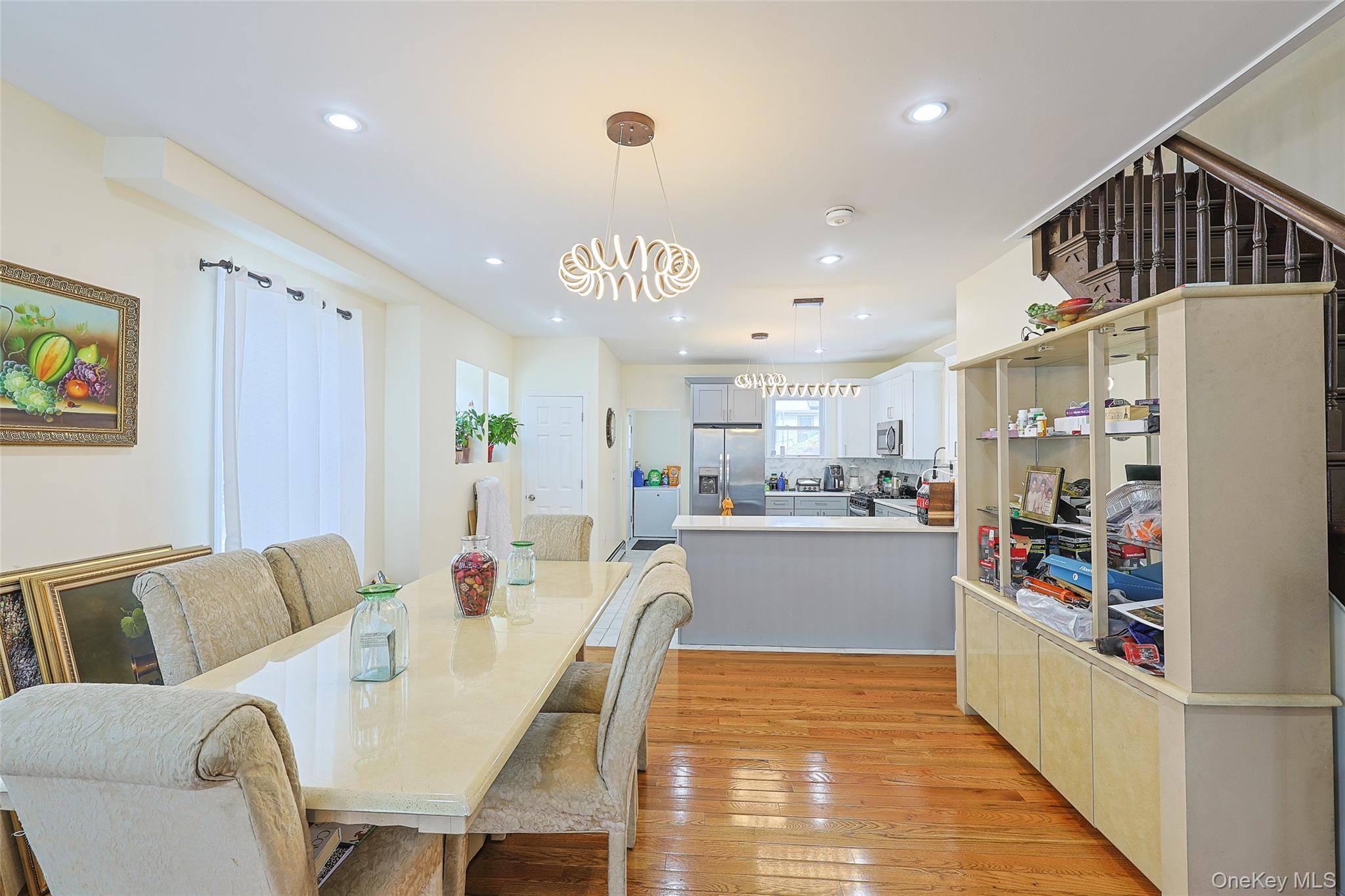 191-68 115th Road Queens, NY 11412 - Photo 5 of 20 a kitchen with stainless steel appliances granite countertop a refrigerator and a dining table