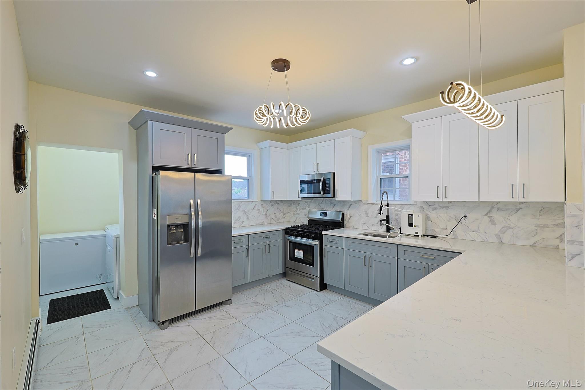 191-68 115th Road Queens, NY 11412 - Photo 7 of 20 a kitchen with cabinets and stainless steel appliances