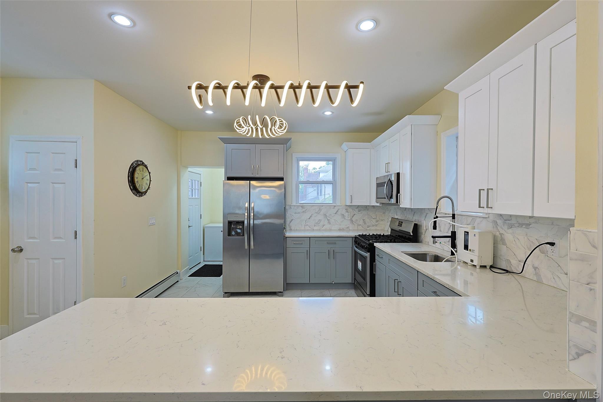 191-68 115th Road Queens, NY 11412 - Photo 8 of 20 a kitchen with stainless steel appliances granite countertop a sink refrigerator and cabinets