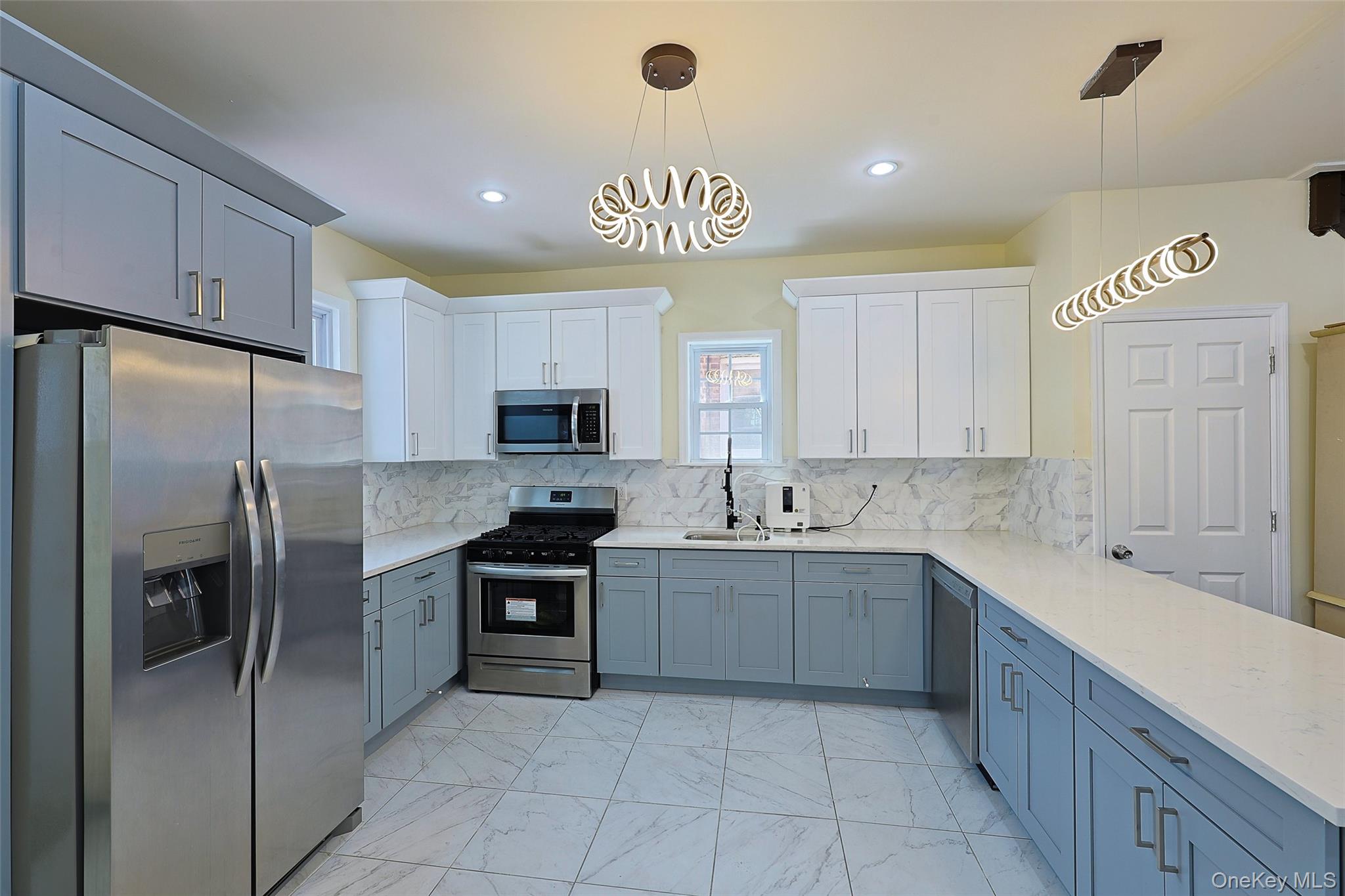 191-68 115th Road Queens, NY 11412 - Photo 9 of 20 a kitchen with stainless steel appliances granite countertop a refrigerator sink and cabinets