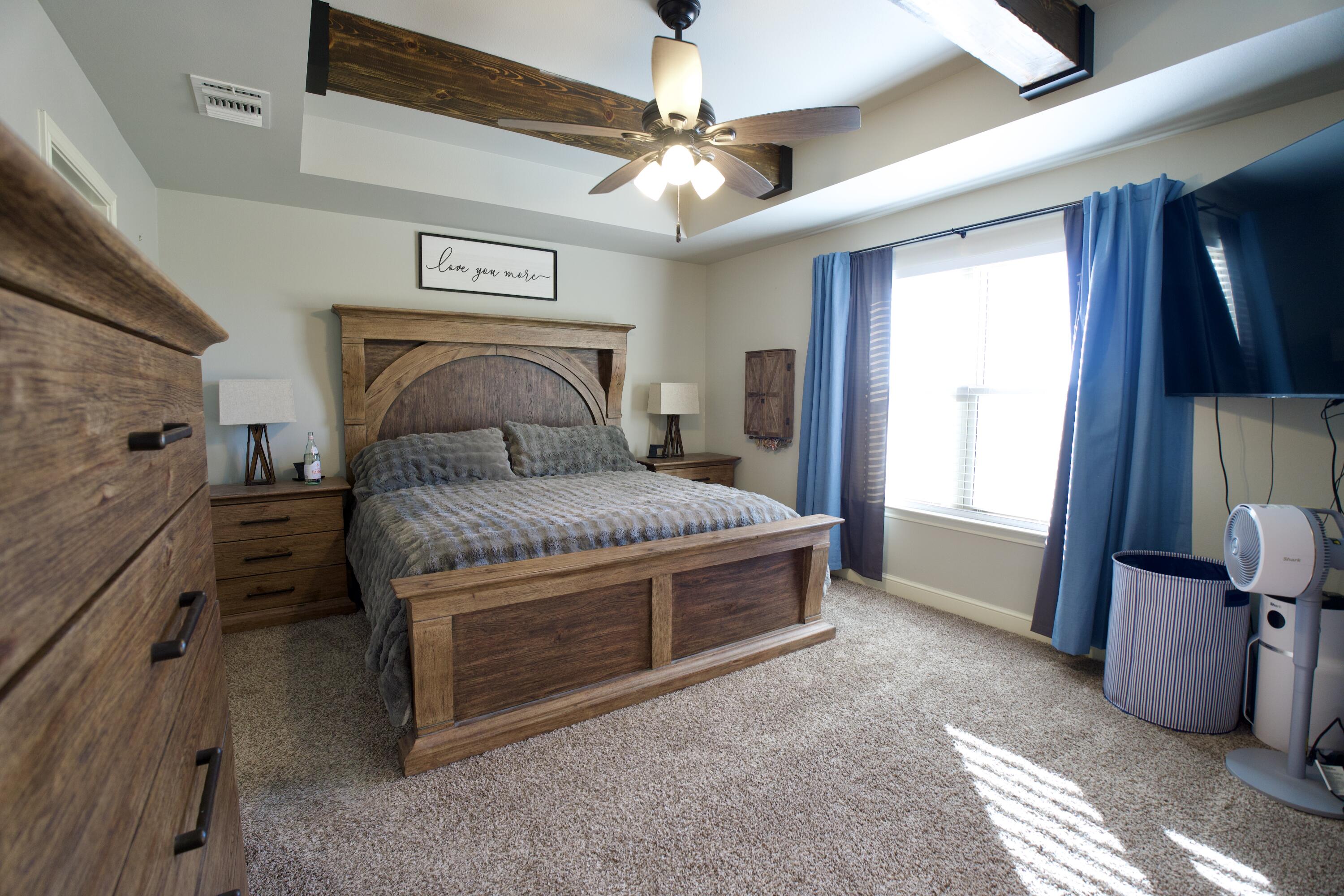 7405 County Road 3700 Slaton, TX 79364 - Photo 11 of 26 a bed room with a bed and a television