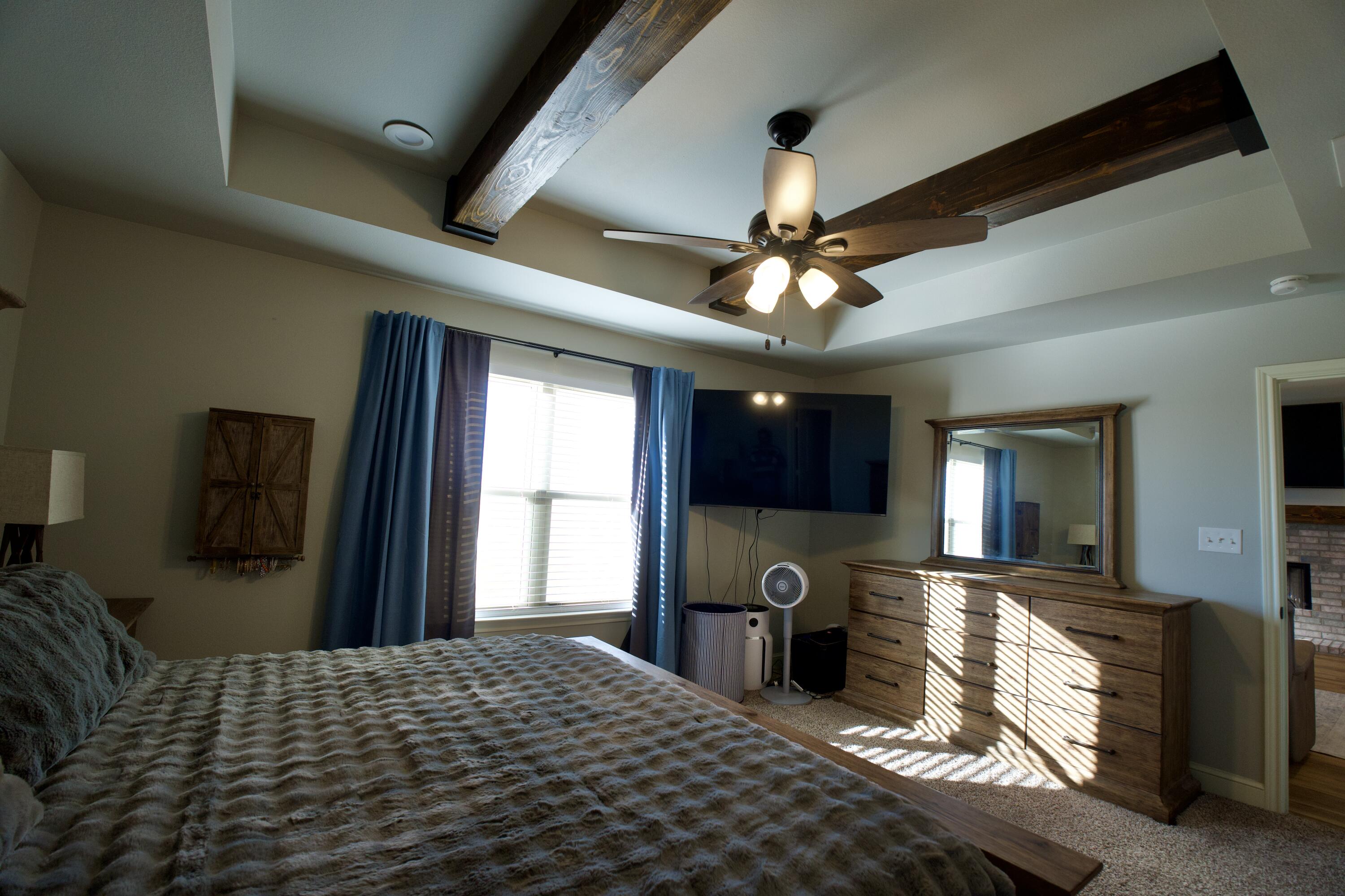 7405 County Road 3700 Slaton, TX 79364 - Photo 12 of 26 a bedroom with a bed and a chandelier