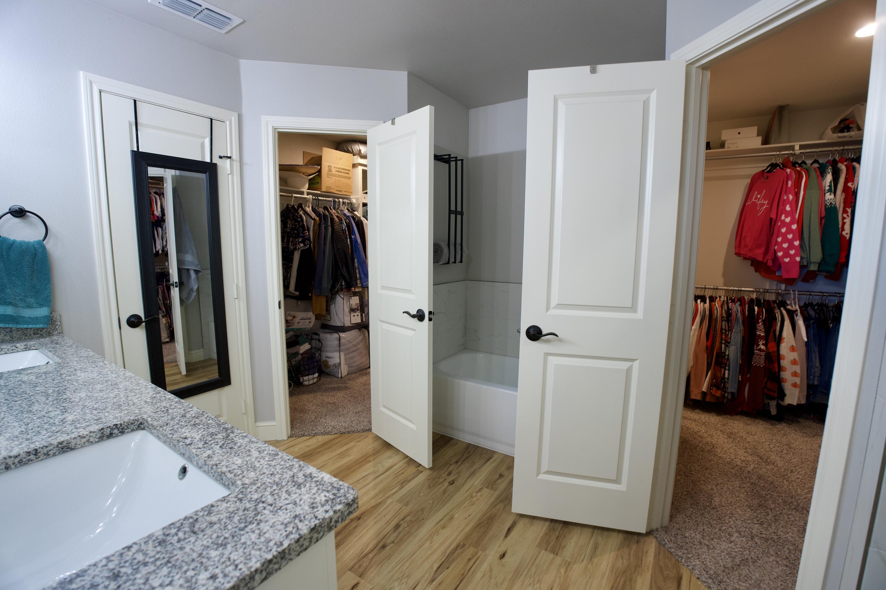 7405 County Road 3700 Slaton, TX 79364 - Photo 13 of 26 a view of walk in closet with clothes and shoes