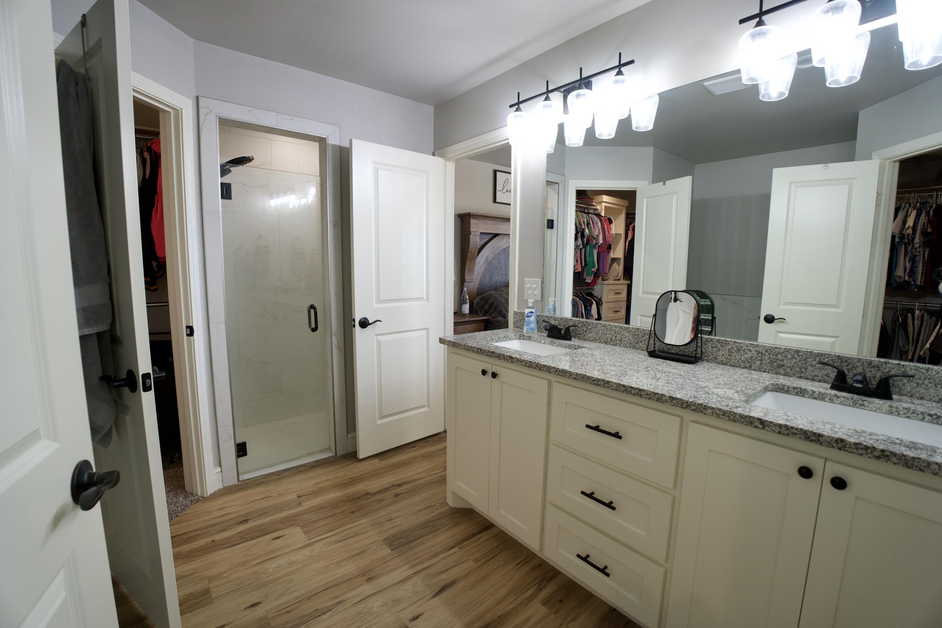 7405 County Road 3700 Slaton, TX 79364 - Photo 14 of 26 a bathroom with a double vanity sink and a mirror