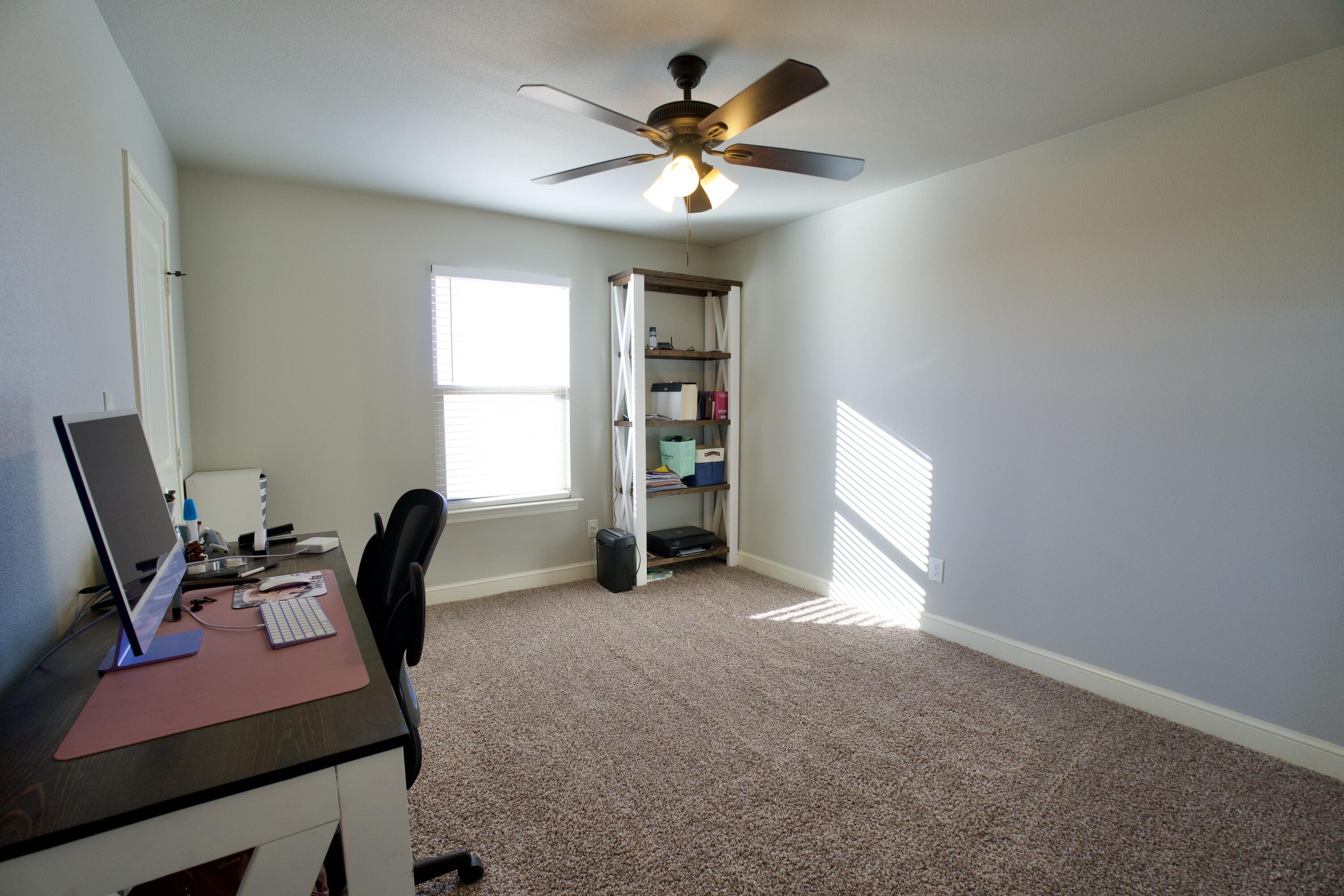 7405 County Road 3700 Slaton, TX 79364 - Photo 20 of 26 a view of a workspace with furniture and a window