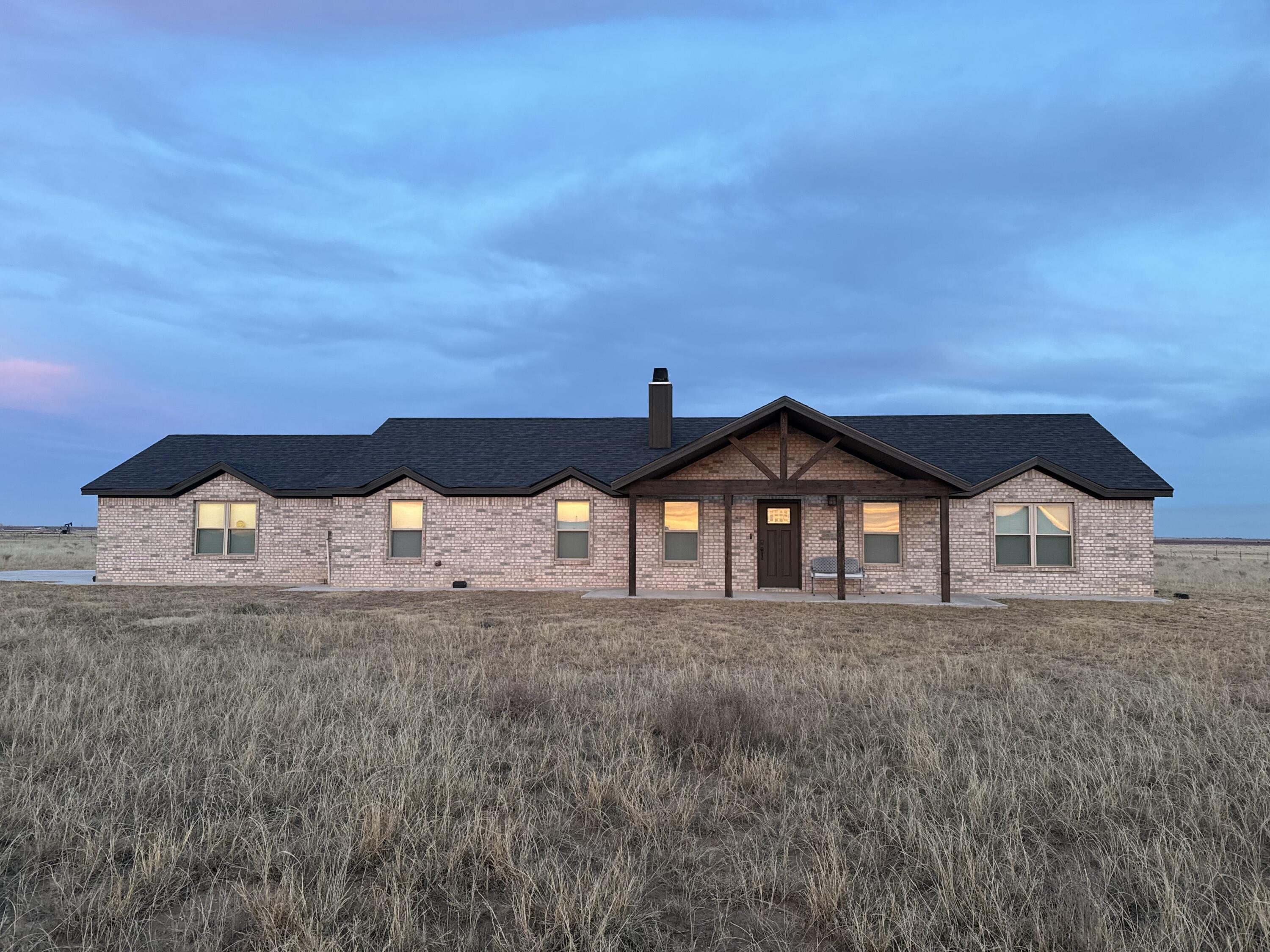 7405 County Road 3700 Slaton, TX 79364 - Photo 26 of 26 a front view of a house with yard and big trees