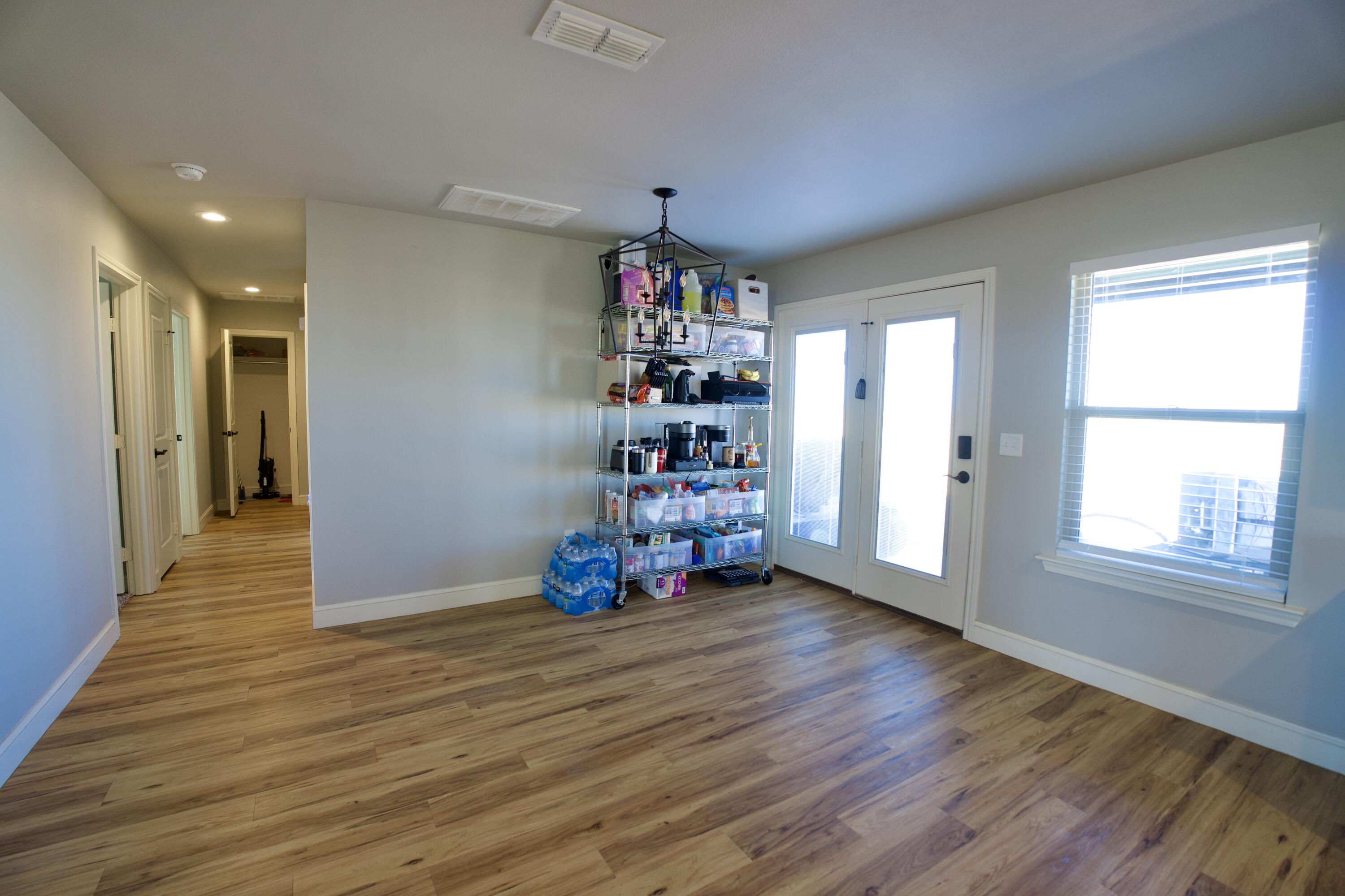 7405 County Road 3700 Slaton, TX 79364 - Photo 9 of 26 a very nice looking room with wooden floor and windows