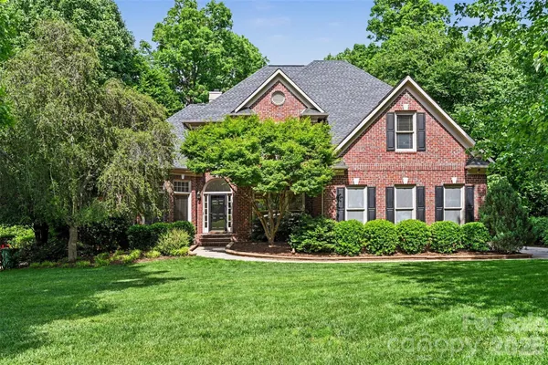 a front view of house with yard and green space