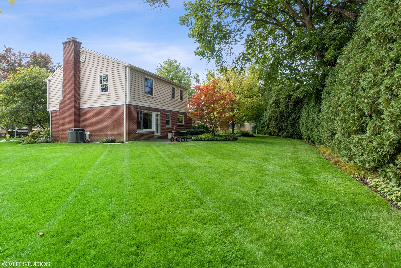 2416 Covert Road Glenview, IL 60025 - Photo 20 of 24 a front view of a house with a yard and trees