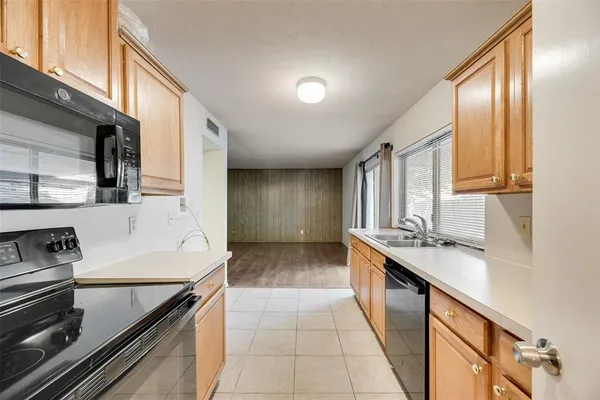 a kitchen with a sink stove and cabinets