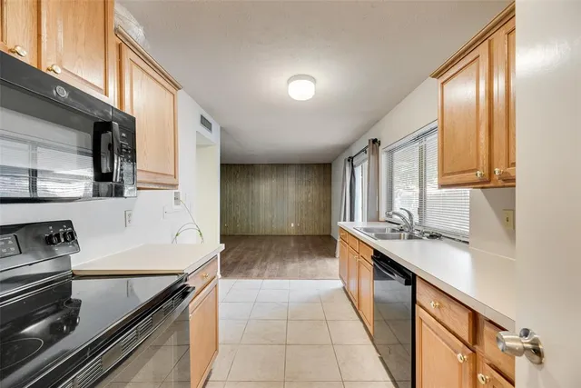 a kitchen with a sink stove and cabinets