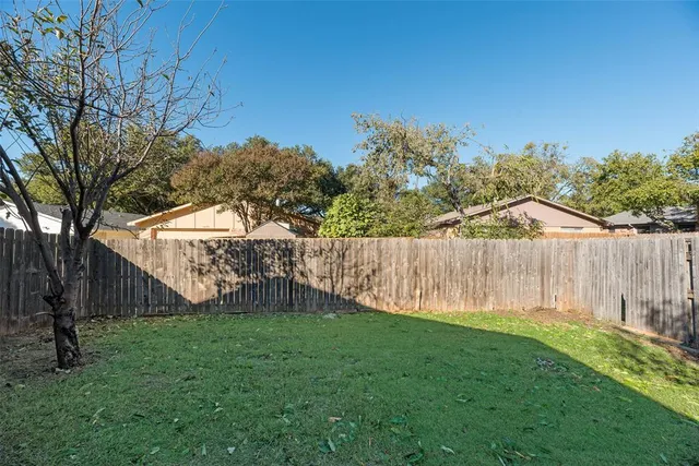 a view of a backyard with a fence