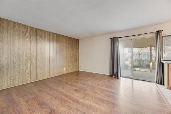 a view of an empty room with glass door