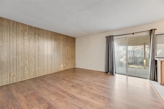 a view of an empty room with glass door