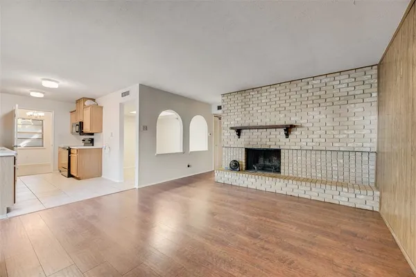 a view of a livingroom with a fireplace and window