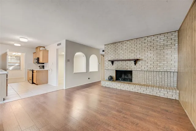 a view of a livingroom with a fireplace and window