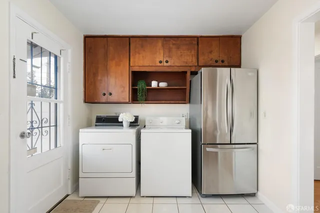 a kitchen with a refrigerator sink and cabinets