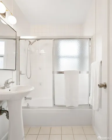 a bathroom with a bathtub a shower a sink and a shower
