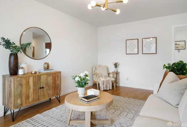 a living room with furniture and a potted plant