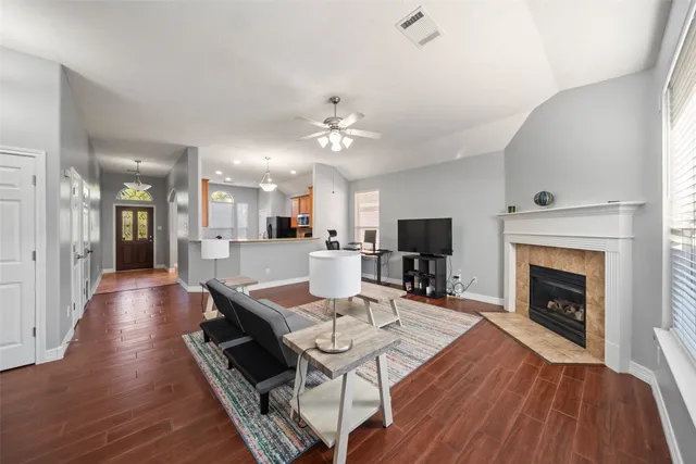 a living room with furniture fireplace and flat screen tv