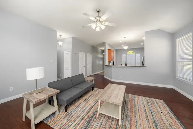 a living room with furniture and a chandelier