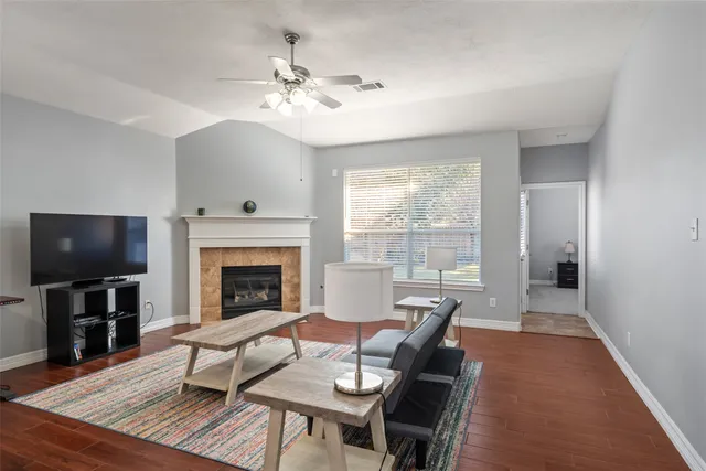 a living room with furniture a fireplace and a flat screen tv