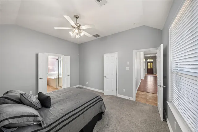 a bedroom with a bed and ceiling fan