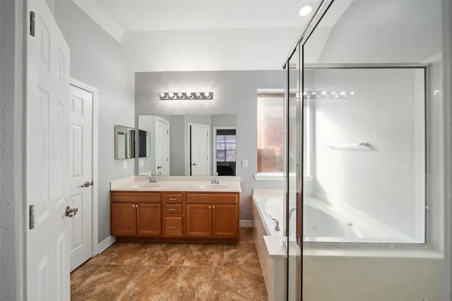 a bathroom with a tub sink shower and mirror