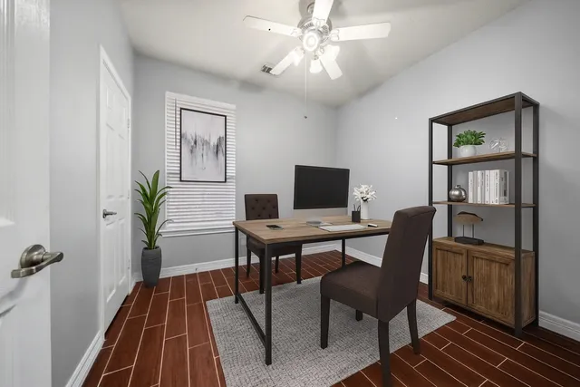 a view of a workspace with furniture and a potted plant