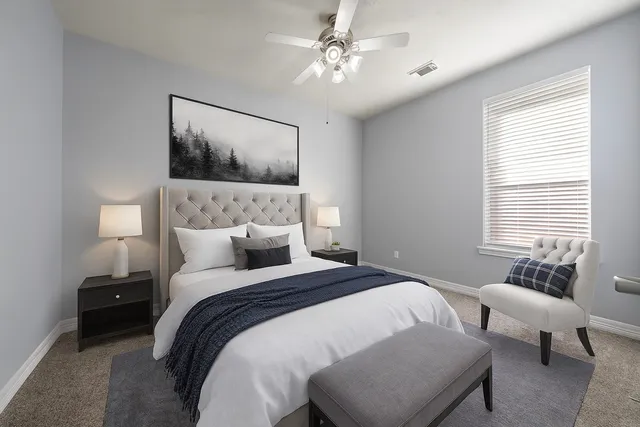 a bedroom with a large bed and a couch