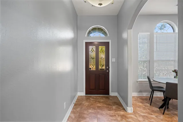 a view of a livingroom with a window and wooden floor