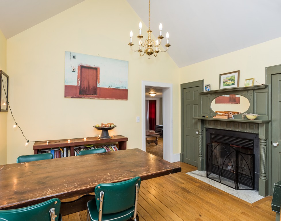 1301 Conway Road Ashfield, MA 01330 - Photo 6 of 26 a room with table chairs and a fireplace