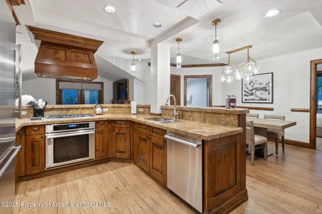 a kitchen with a stove and a wooden floors