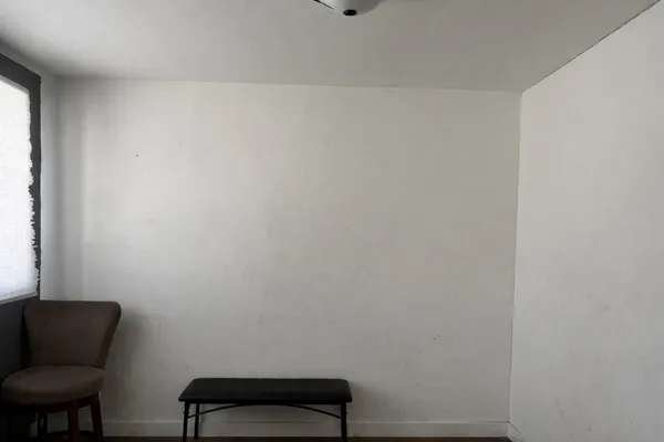a room with a chair and a window