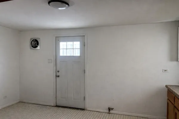 an empty room with windows and closet