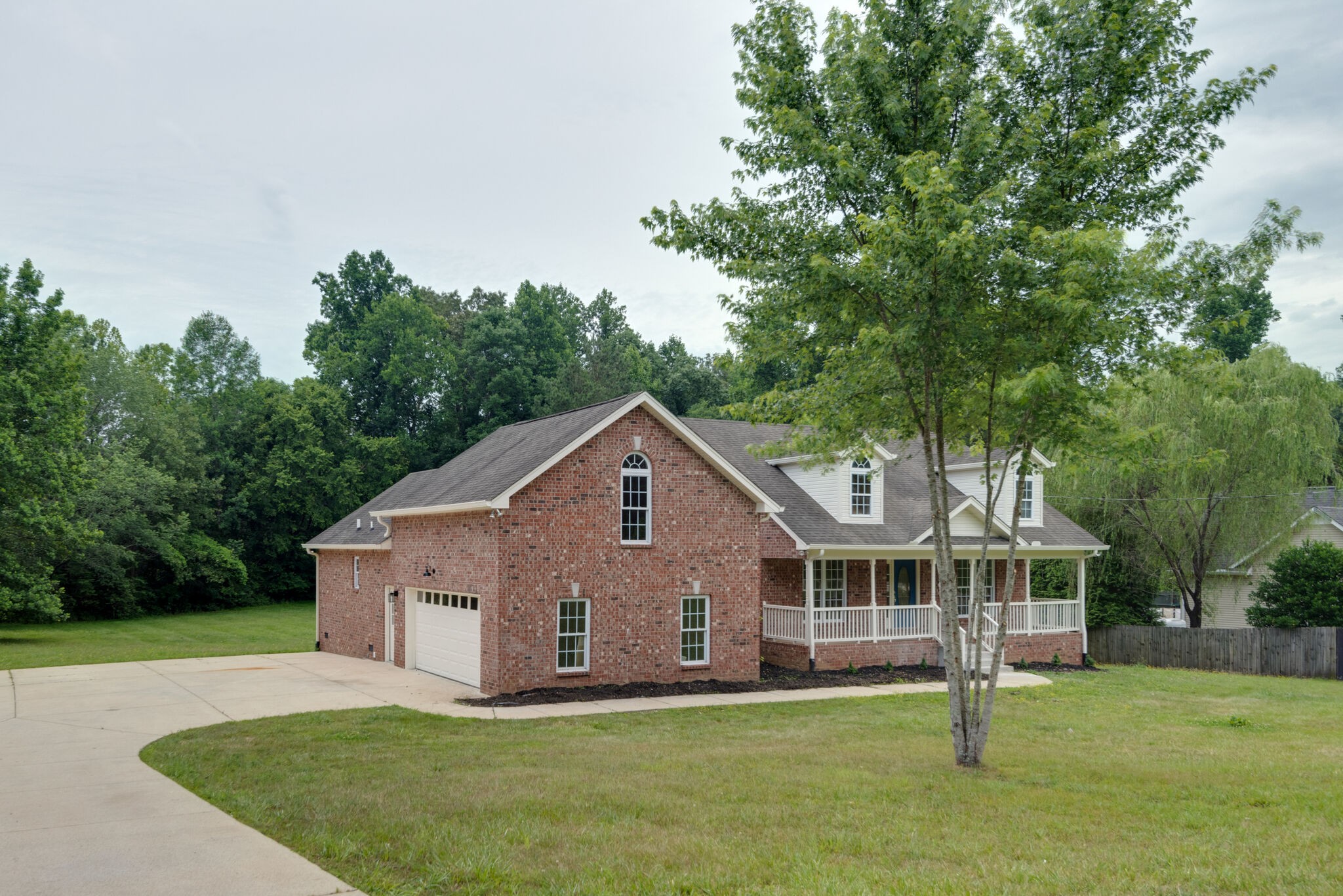 2005 Spencer Mill Road Burns, TN 37029 - Photo 1 of 30 a front view of a house with a yard and trees