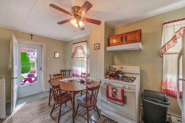 a table and chairs in a dining room with a window
