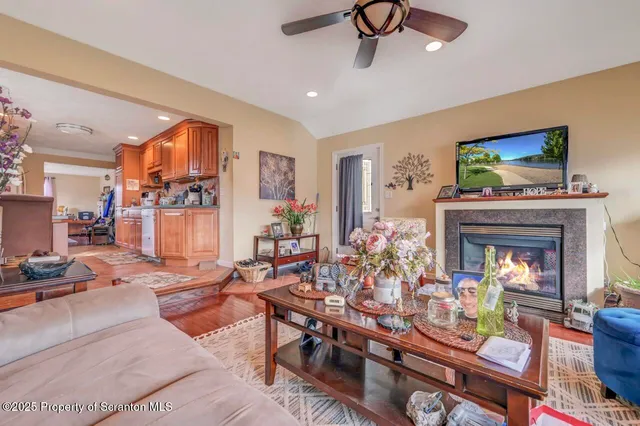 a kitchen with stainless steel appliances refrigerator stove dining table and chairs