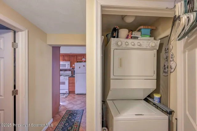 a bathroom with a granite countertop sink mirror vanity and toilet