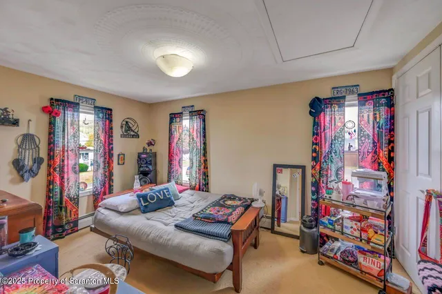 a bedroom with a bed and a dresser with mirror