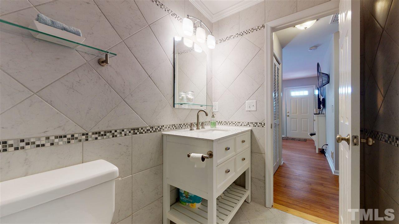 1228 South State Street, Unit A Raleigh, NC 27610 - Photo 13 of 17 a bathroom with a sink a toilet and shower