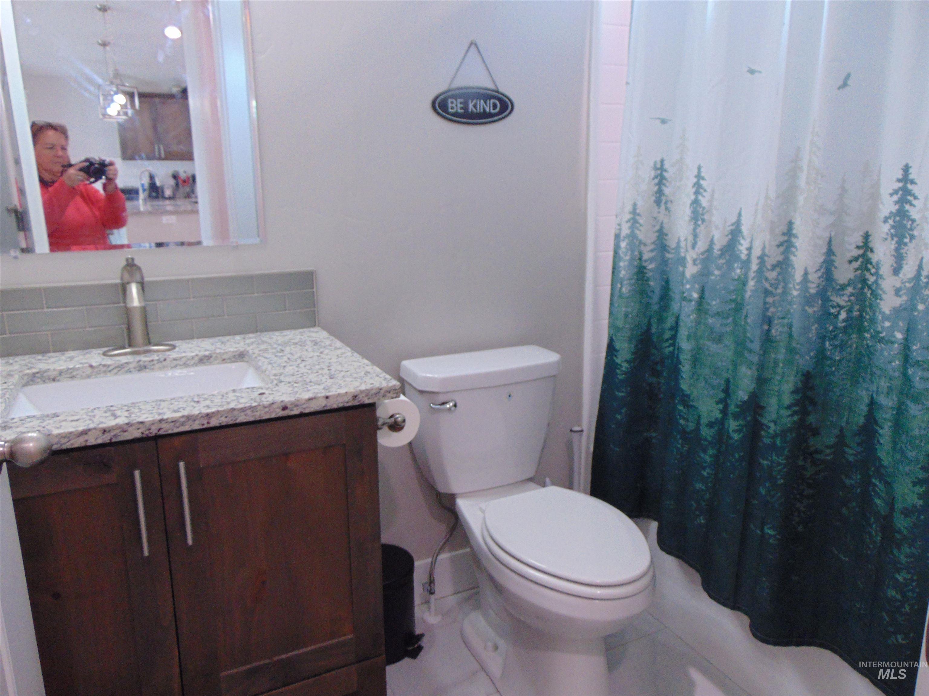 901 Campbell Street Vale, OR 97918 - Photo 13 of 22 Full bath with vanity, a shower with curtain, and decorative backsplash