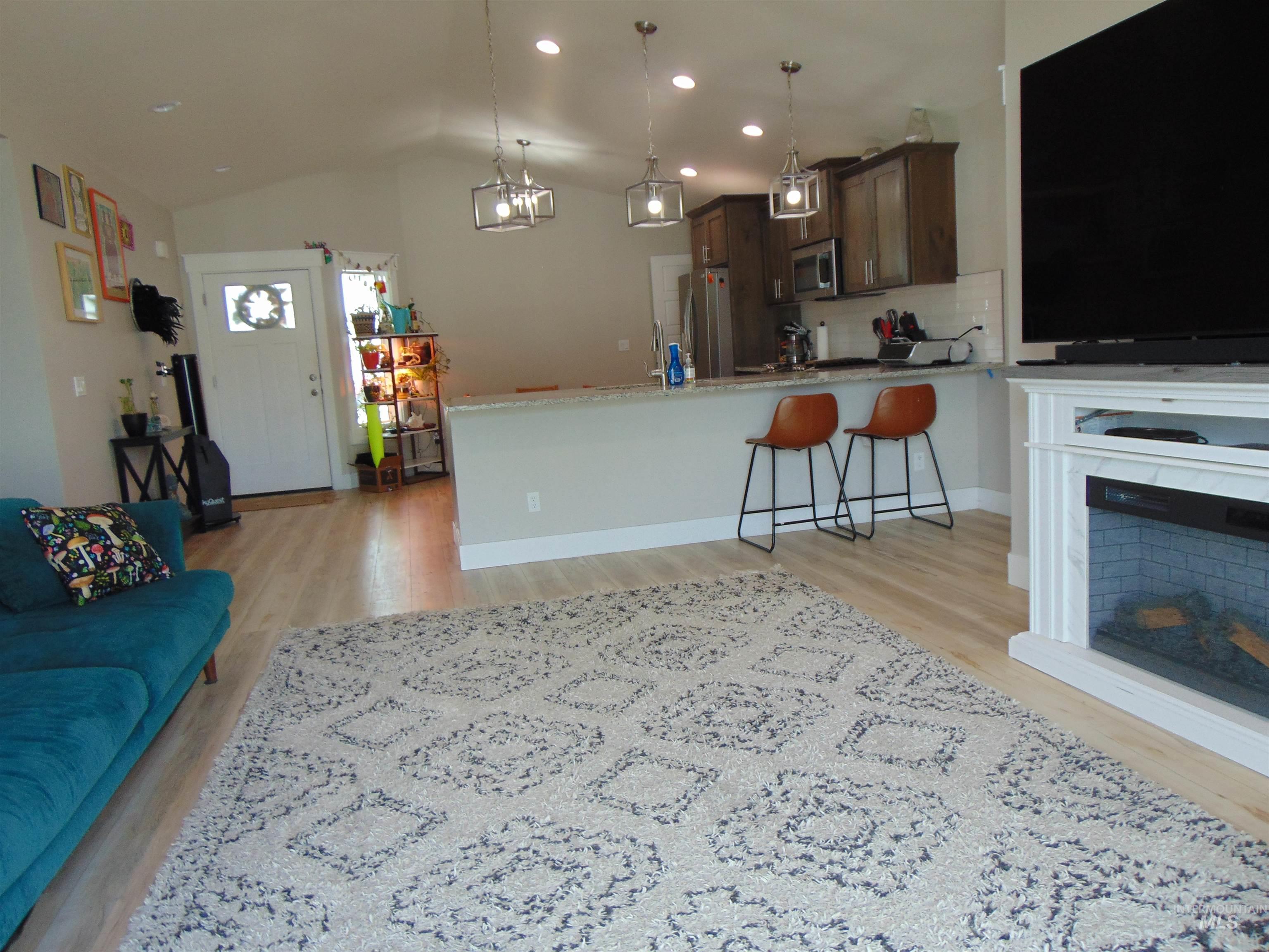 901 Campbell Street Vale, OR 97918 - Photo 16 of 22 Living area featuring light wood-type flooring, lofted ceiling, and recessed lighting
