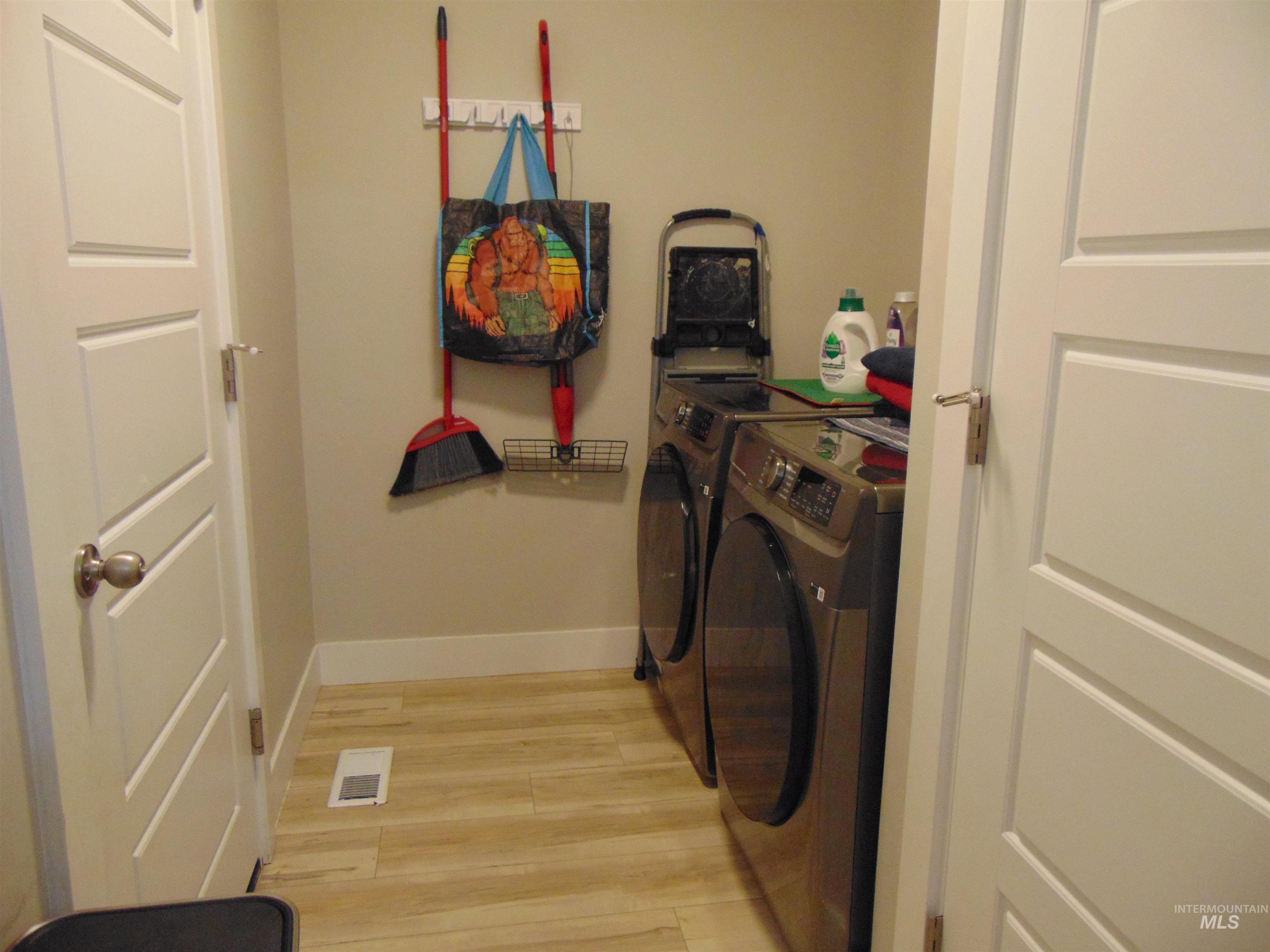 901 Campbell Street Vale, OR 97918 - Photo 17 of 22 Laundry area featuring light wood-style floors and washer and clothes dryer