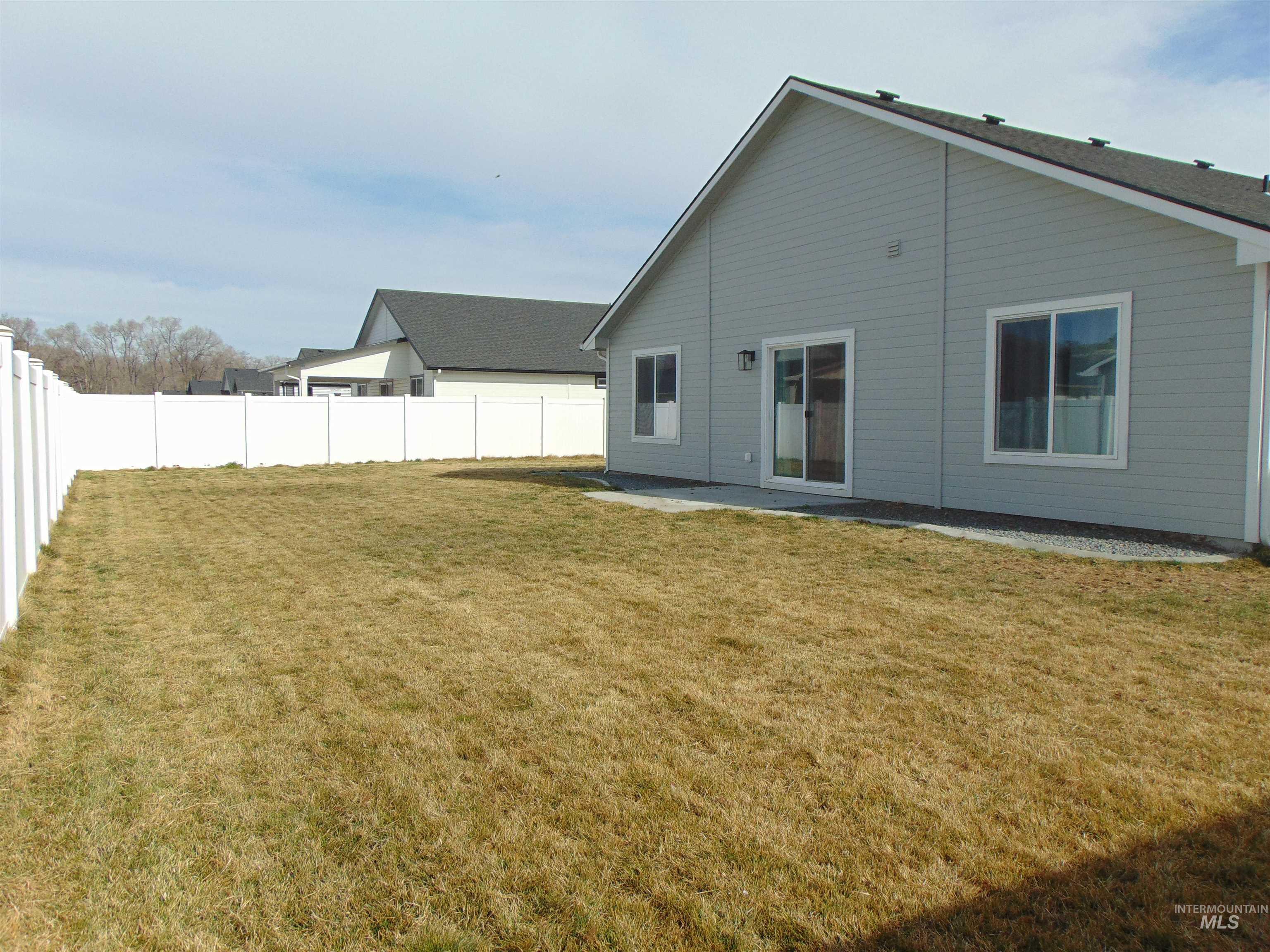 901 Campbell Street Vale, OR 97918 - Photo 19 of 22 Rear view of house featuring a patio area and a fenced backyard