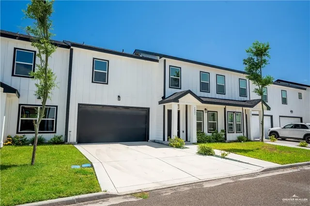 a front view of a house with a yard