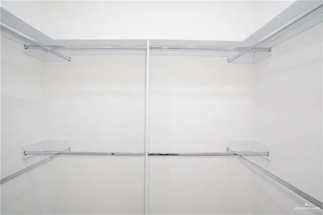 an empty room with a window and a ceiling fan