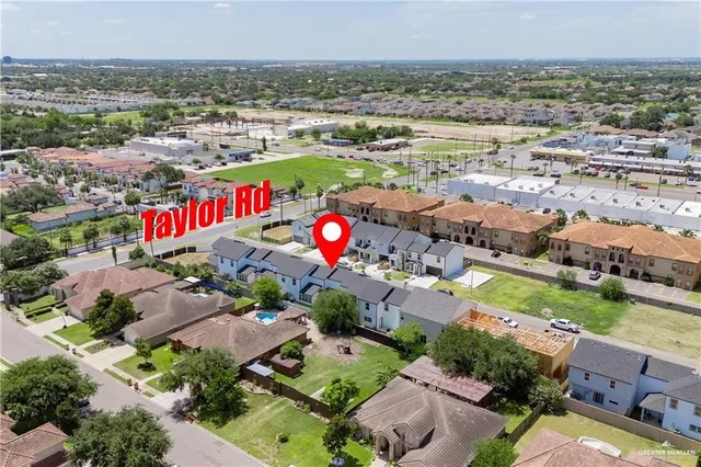 aerial view of a house with a yard and a garage