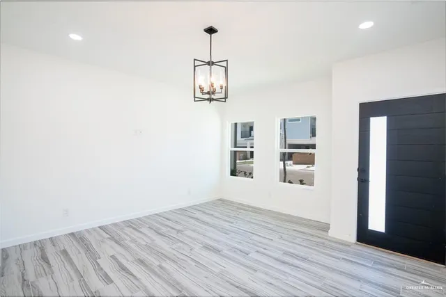 a view of a kitchen with wooden floor and a ceiling fan